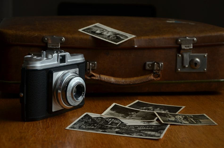 Camera And Suitcase With Photographs