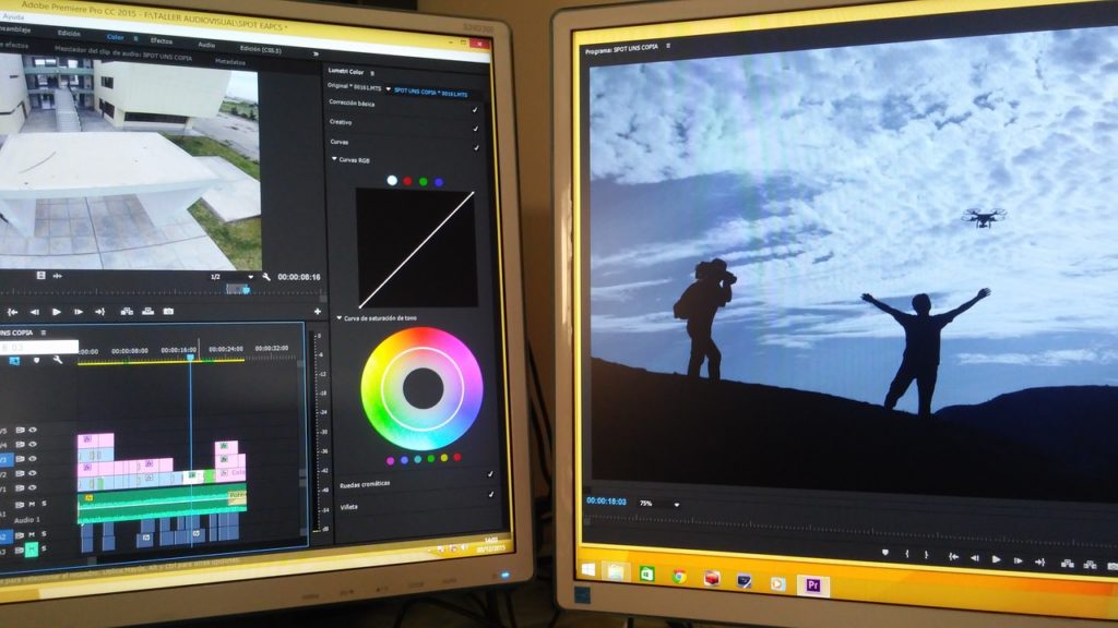 two computer monitors displaying Premiere Pro