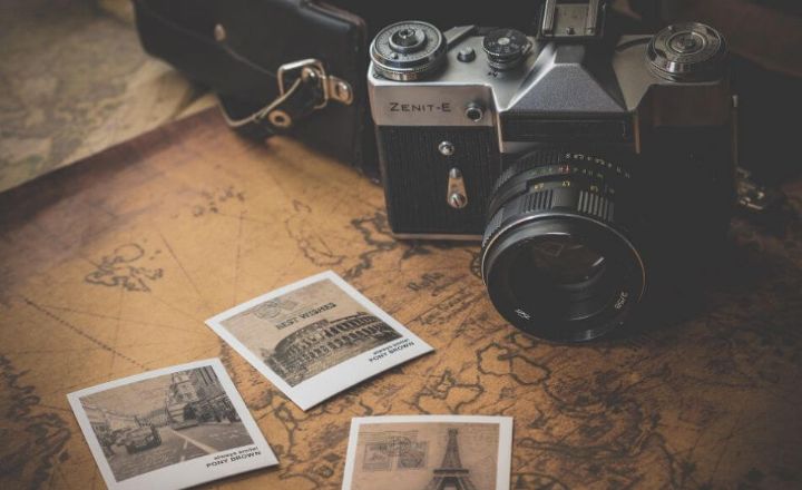 camera and photographs on top of a map