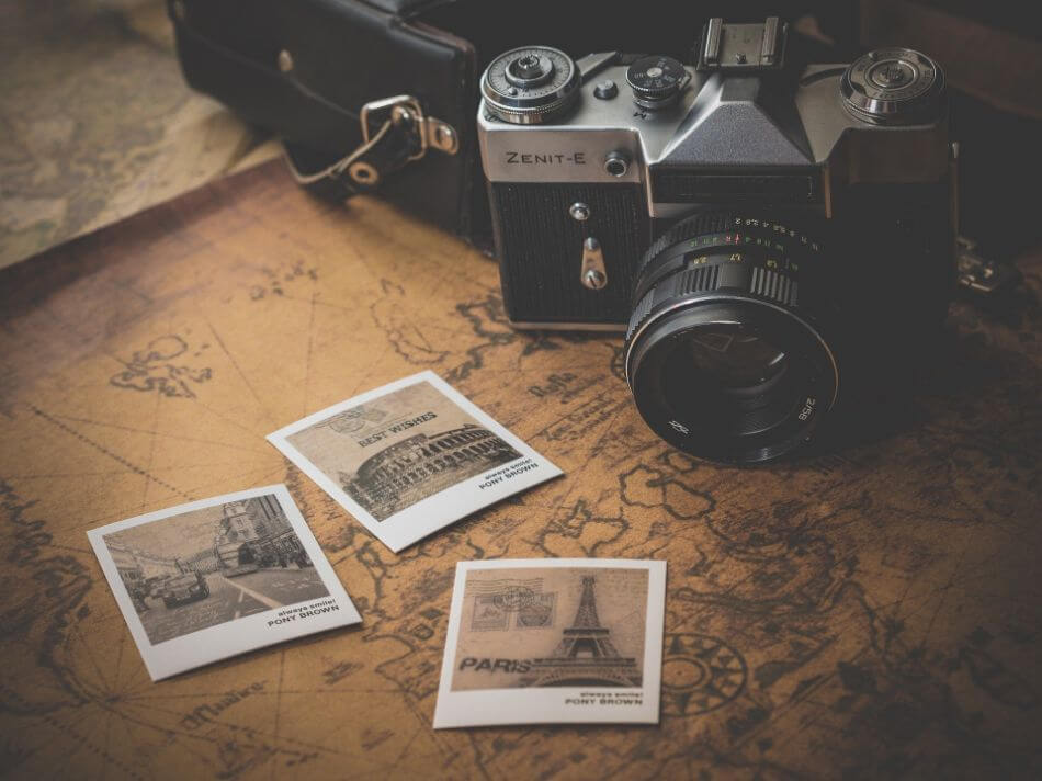 camera and photographs on top of a map