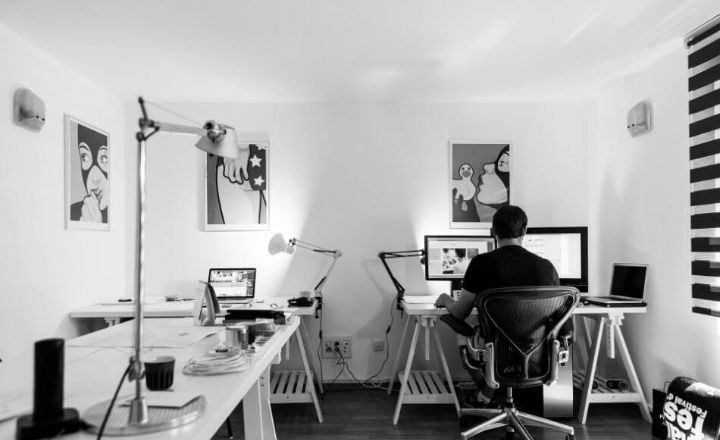 black and white photo of man in studio on computer