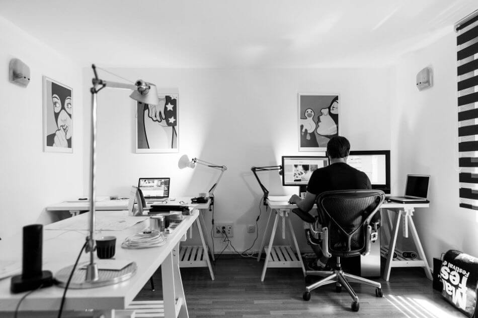 black and white photo of man in studio on computer