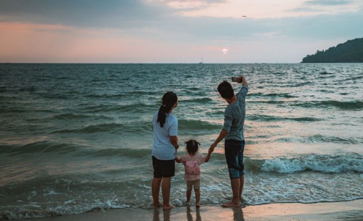 family taking a selfie at beach